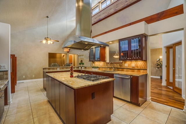 kitchen with backsplash, light tile patterned floors, island exhaust hood, stainless steel appliances, and a sink