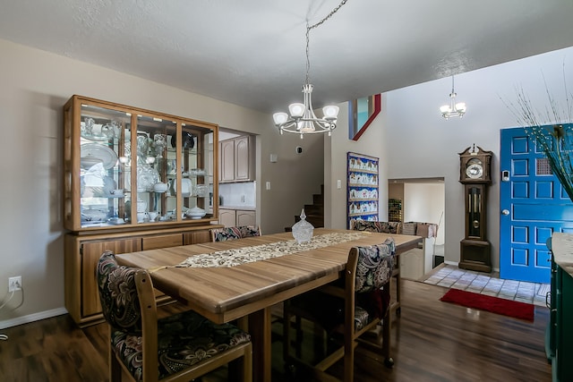 dining room featuring a notable chandelier, baseboards, and wood finished floors