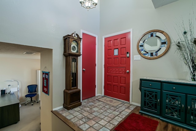 entrance foyer with baseboards and visible vents