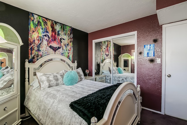 bedroom with a closet and a textured wall