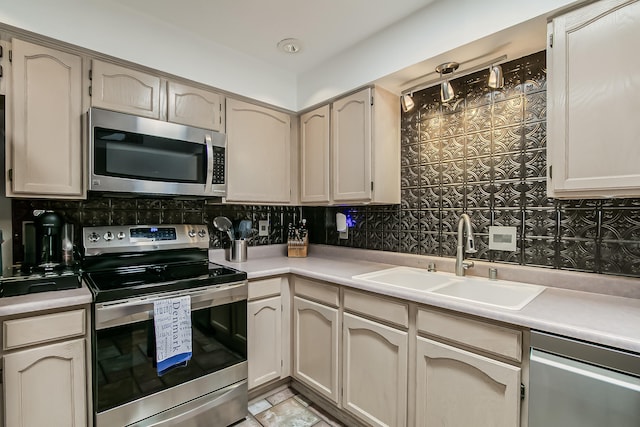 kitchen with decorative backsplash, stainless steel appliances, light countertops, and a sink