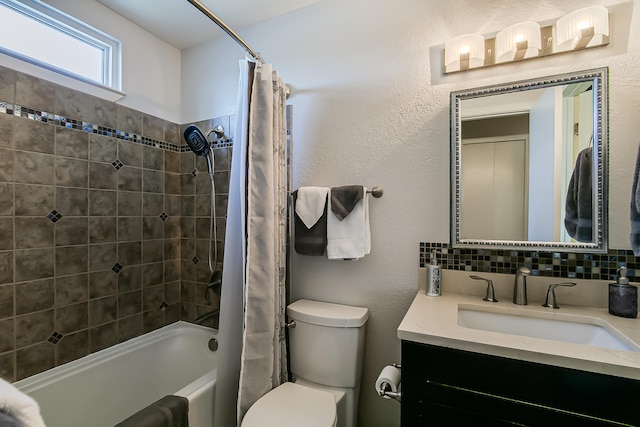 bathroom featuring vanity, shower / tub combo, toilet, a textured wall, and tasteful backsplash