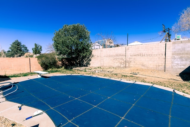 view of swimming pool with a fenced backyard