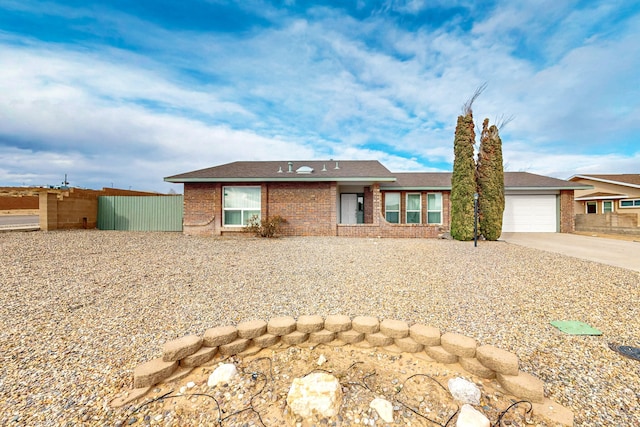 view of front of home with a garage, brick siding, and concrete driveway