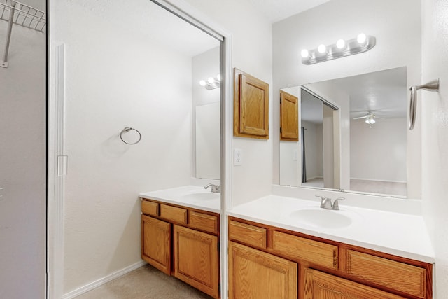 full bathroom featuring ceiling fan, double vanity, and a sink