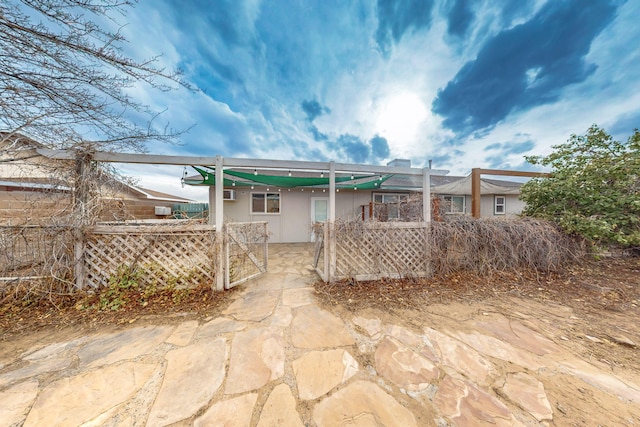 back of property featuring a patio, fence, and stucco siding