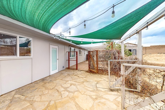 view of patio / terrace with an outdoor structure and a fenced backyard