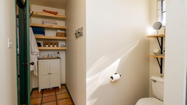 bathroom with tile patterned floors and toilet