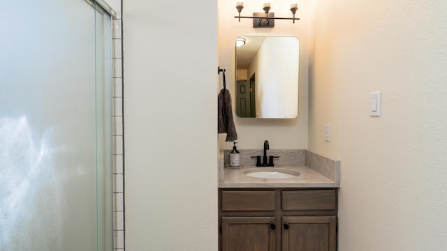 bathroom featuring an enclosed shower and vanity