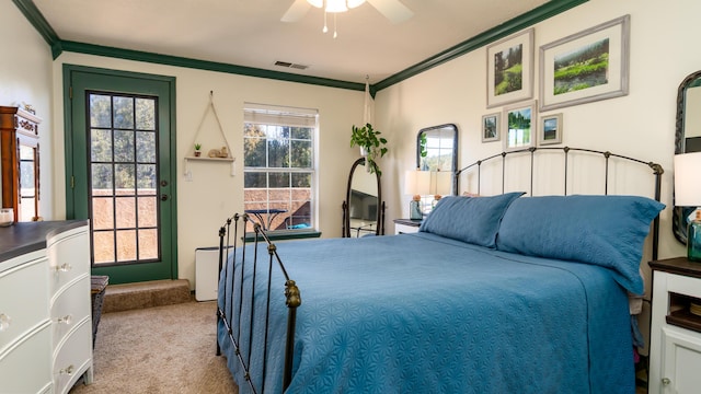 bedroom with ceiling fan, carpet flooring, visible vents, and ornamental molding