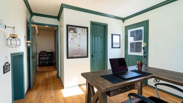 office featuring crown molding, light wood-style floors, and baseboards