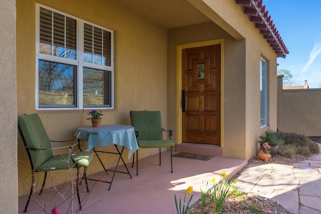 property entrance featuring stucco siding