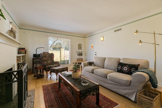 living area with visible vents and light wood-type flooring