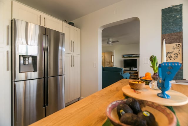 kitchen featuring butcher block counters, white cabinets, and stainless steel refrigerator with ice dispenser