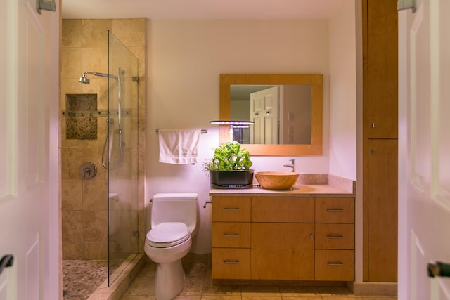 full bathroom featuring tile patterned floors, toilet, a stall shower, and vanity