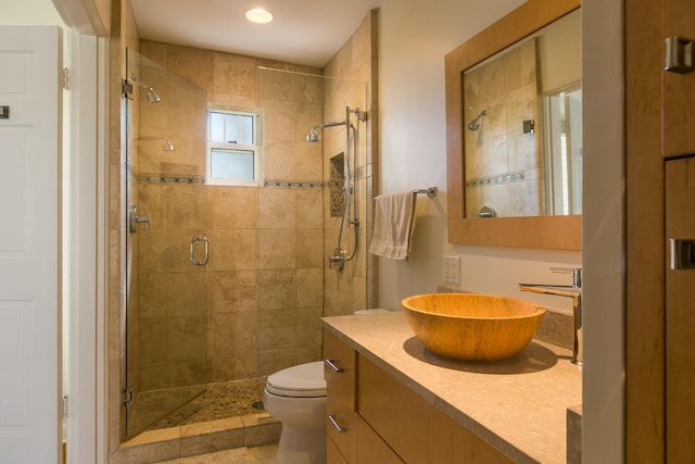 full bath featuring vanity, toilet, and a shower stall