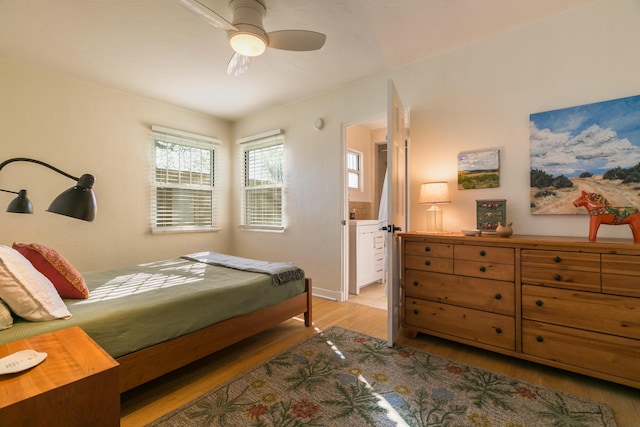 bedroom featuring a ceiling fan, light wood-type flooring, and ensuite bathroom