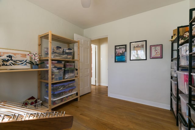 bedroom with baseboards and wood finished floors