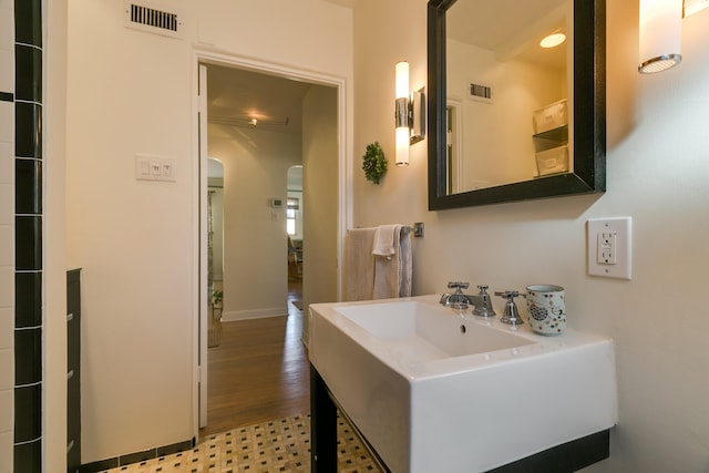 bathroom with visible vents and a sink