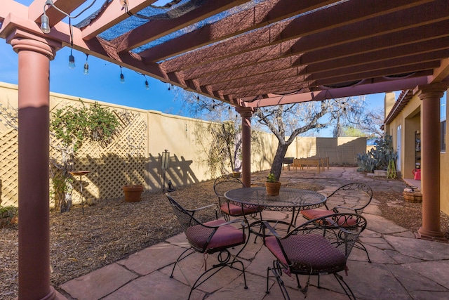 view of patio featuring outdoor dining space, a pergola, and a fenced backyard