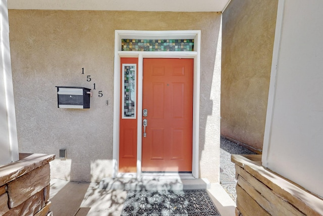 doorway to property with stucco siding