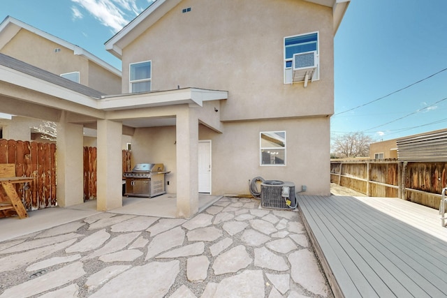 back of house featuring a patio area, cooling unit, fence, and stucco siding