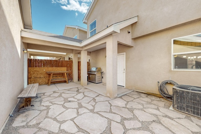 view of patio / terrace featuring central air condition unit, fence, and area for grilling