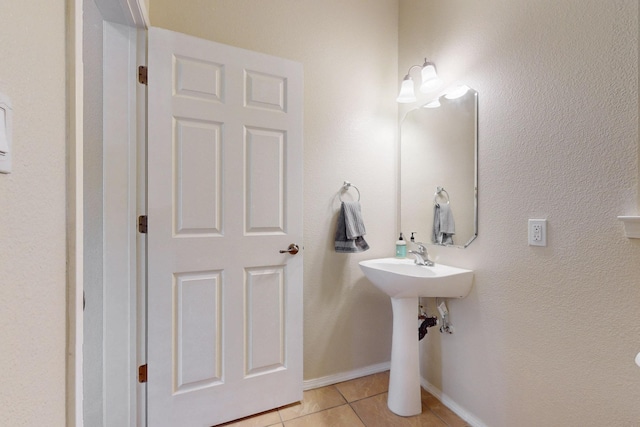 bathroom featuring tile patterned flooring and baseboards