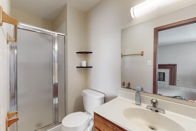 full bathroom with toilet, a stall shower, and vanity