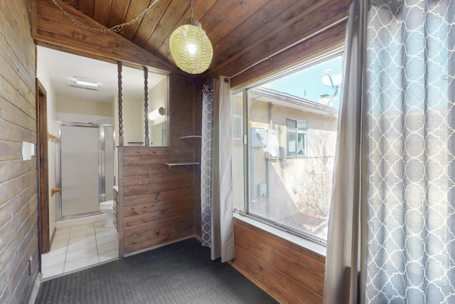 interior space with tile patterned flooring, wood walls, wood ceiling, and carpet