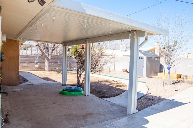 view of patio with a fenced backyard, a storage shed, and an outdoor structure