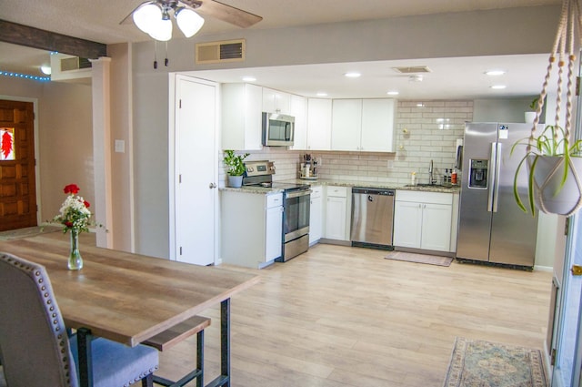 kitchen with light wood finished floors, a ceiling fan, visible vents, and appliances with stainless steel finishes