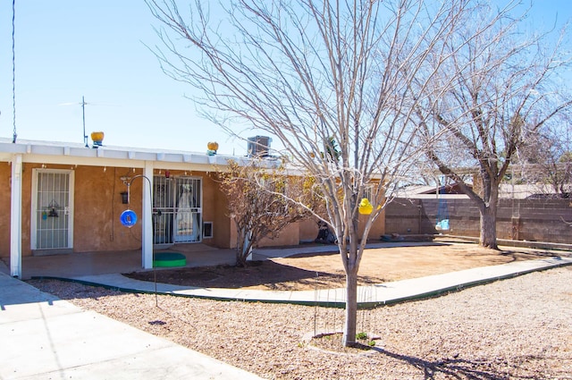 single story home with fence and stucco siding