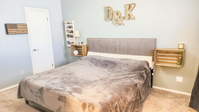 carpeted bedroom featuring baseboards