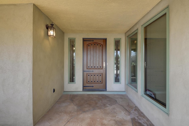 property entrance featuring stucco siding