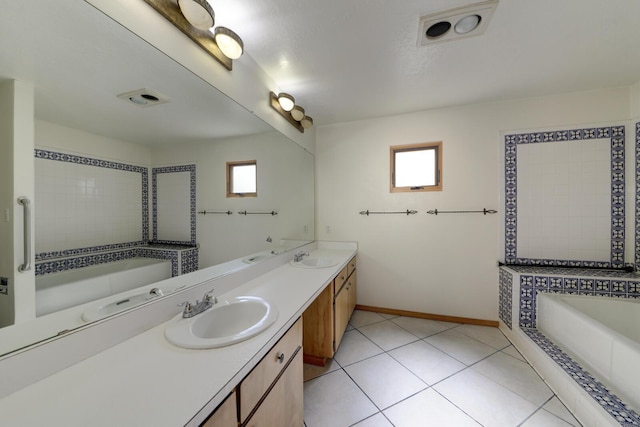 bathroom with a bath, plenty of natural light, visible vents, and a sink