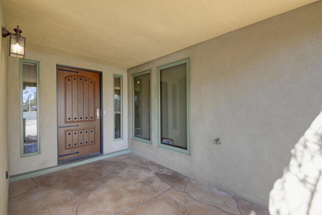 property entrance featuring stucco siding