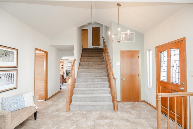 foyer featuring visible vents, baseboards, a chandelier, stairway, and vaulted ceiling