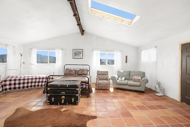 tiled bedroom with vaulted ceiling with skylight