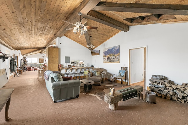 living area with beamed ceiling, wooden ceiling, brick floor, and a ceiling fan