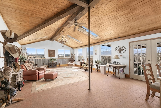 sunroom featuring ceiling fan with notable chandelier, wooden ceiling, and lofted ceiling with beams