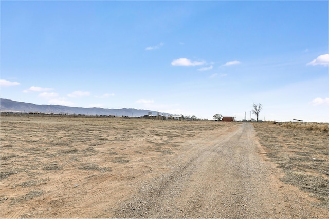 view of street with a rural view and a mountain view