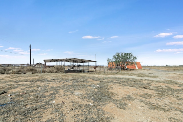 view of yard with an outbuilding and a rural view