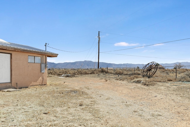 view of yard with a mountain view and fence