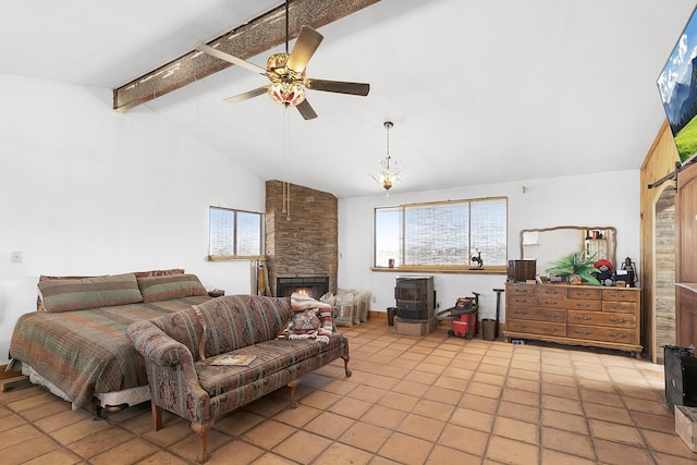 bedroom featuring a stone fireplace, multiple windows, lofted ceiling with beams, and ceiling fan