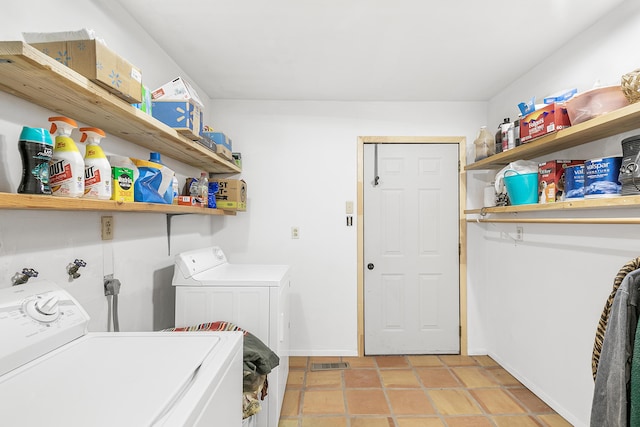 laundry room with visible vents, separate washer and dryer, light tile patterned floors, baseboards, and laundry area