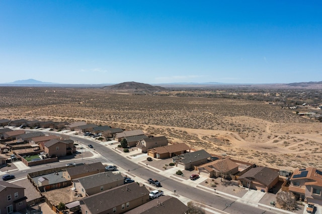 aerial view featuring a desert view, a mountain view, and a residential view