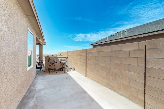 view of patio / terrace featuring fence