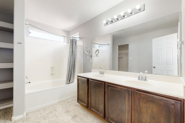 full bathroom featuring a sink, a textured ceiling, shower / bath combo, and double vanity