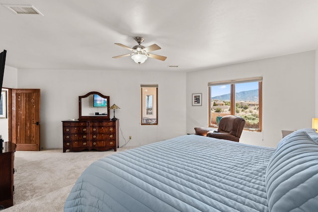 carpeted bedroom featuring visible vents and a ceiling fan